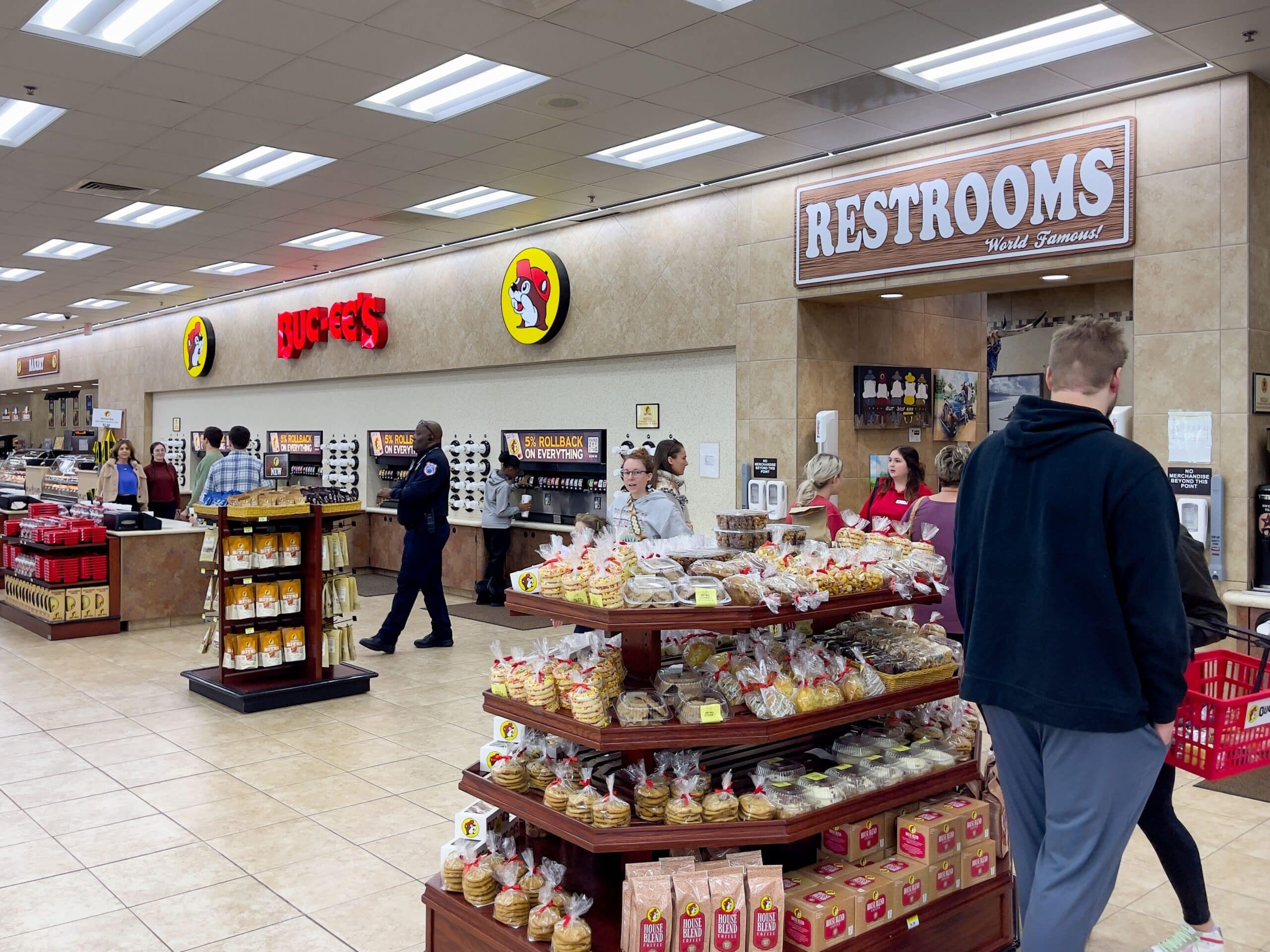 Customers browse packaged snacks and baked goods inside a Buc-ee's travel center.