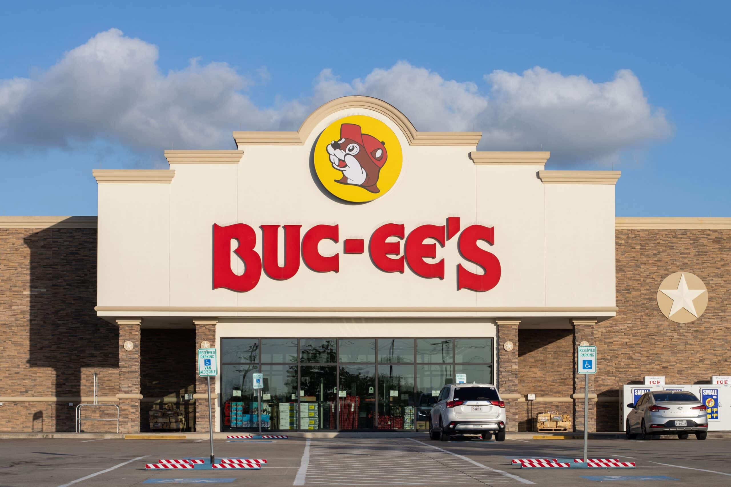 Exterior view of a Buc-ee's travel center featuring the brand's signature beaver logo above the main entrance.