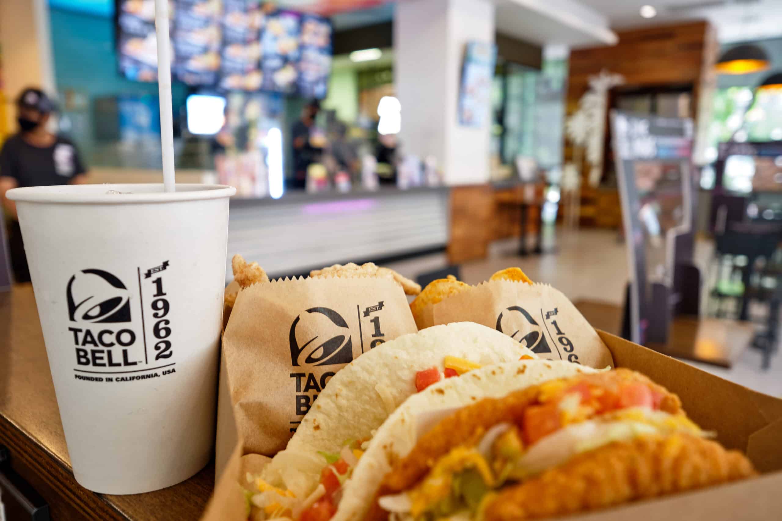 Taco Bell meal arranged on a table inside a restaurant.