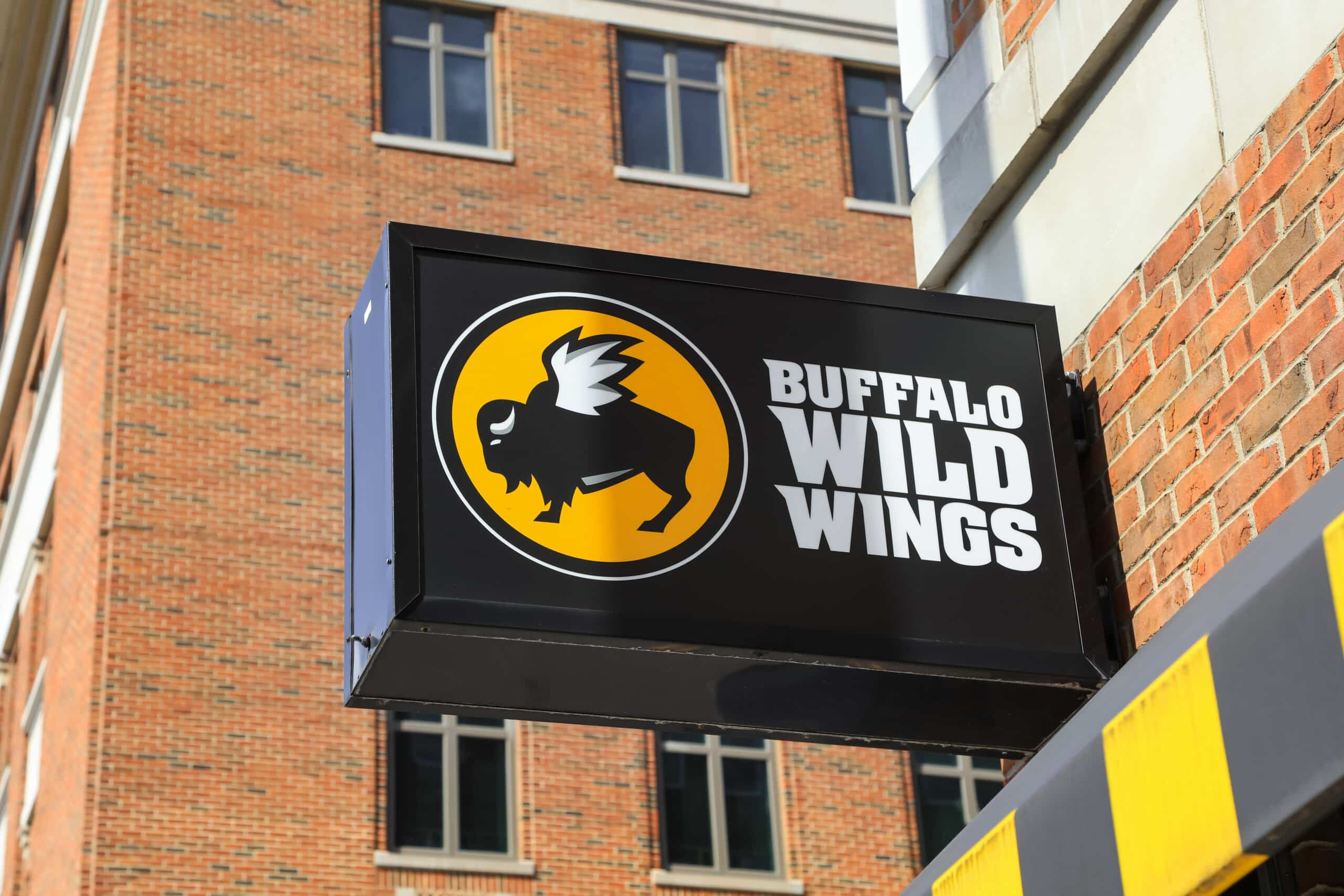 The Buffalo Wild Wings logo and name displayed on an exterior storefront sign.