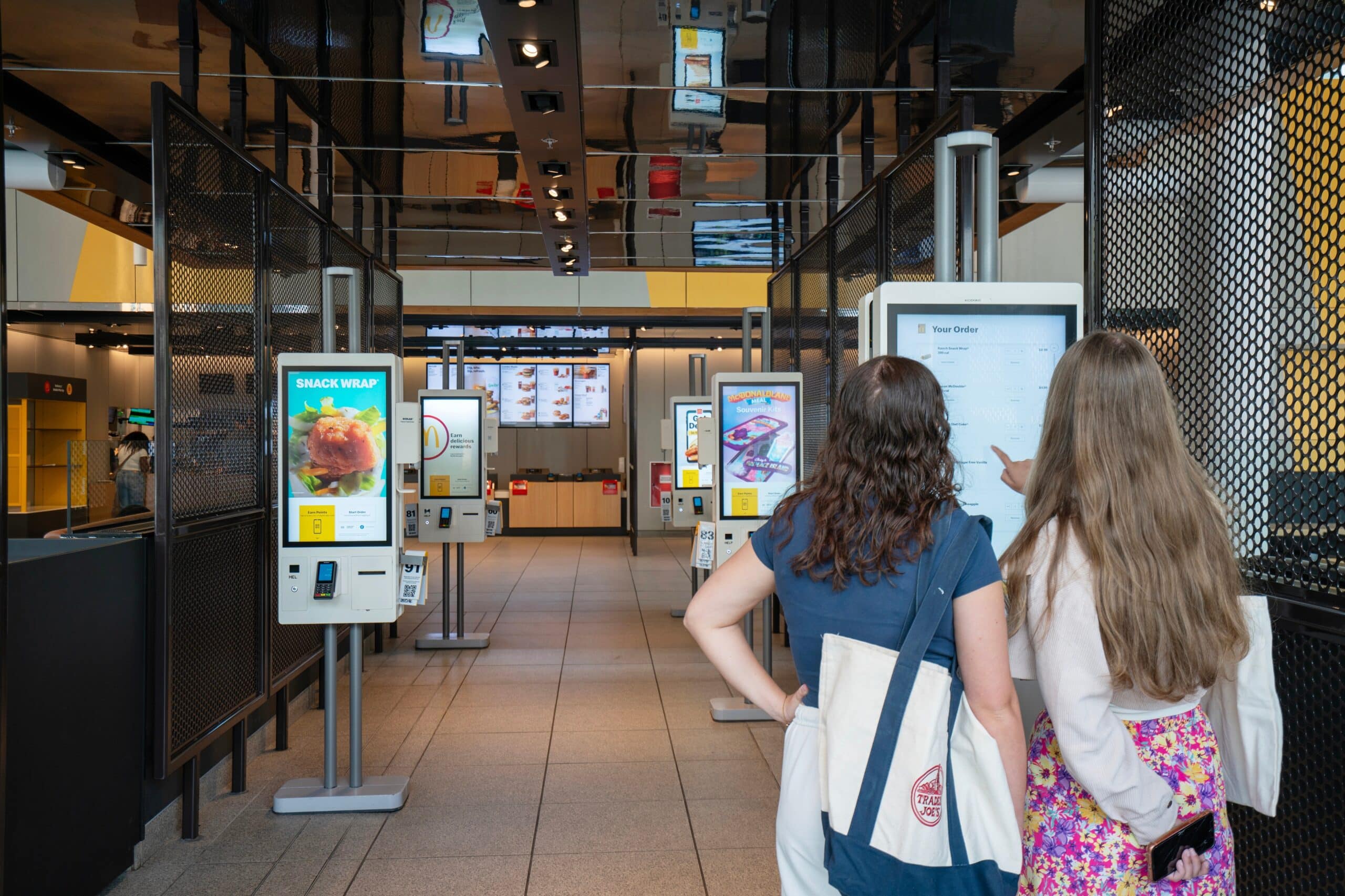 McDonald's customers using self-checkout kiosks.