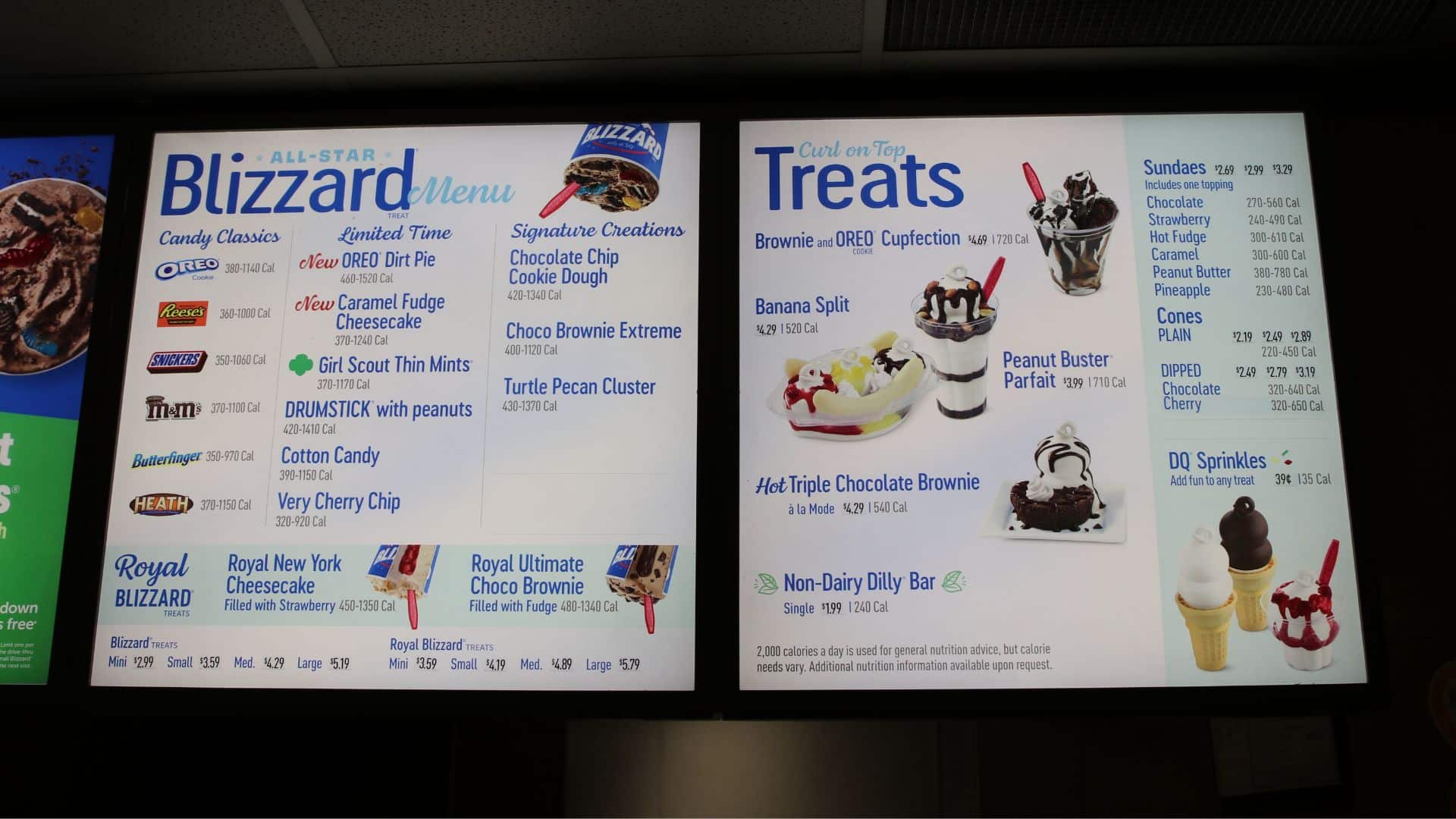 Dairy Queen menu boards displaying Blizzard treats, sundaes, cones, and other desserts.