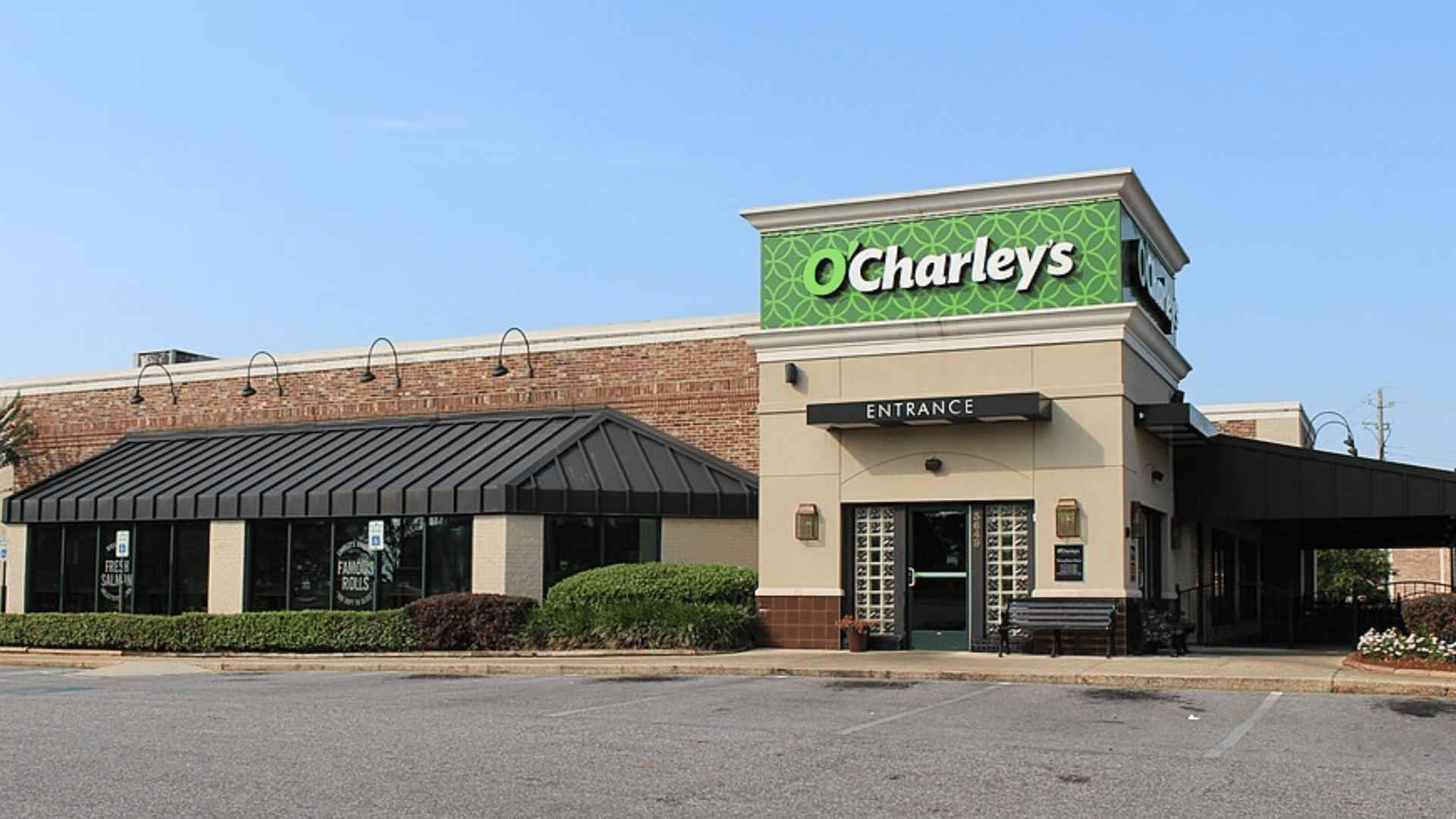 Exterior of an O'Charley's restaurant with a bright green sign above the entrance.
