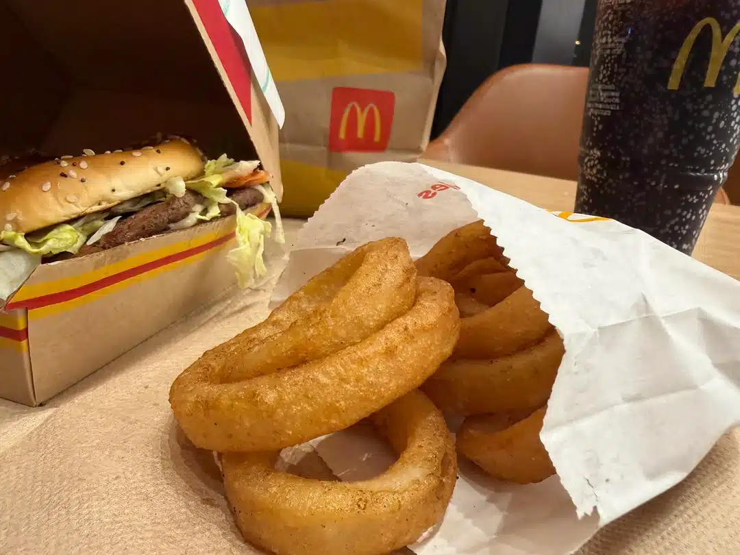 McDonald’s onion rings served alongside a burger and soft drink.