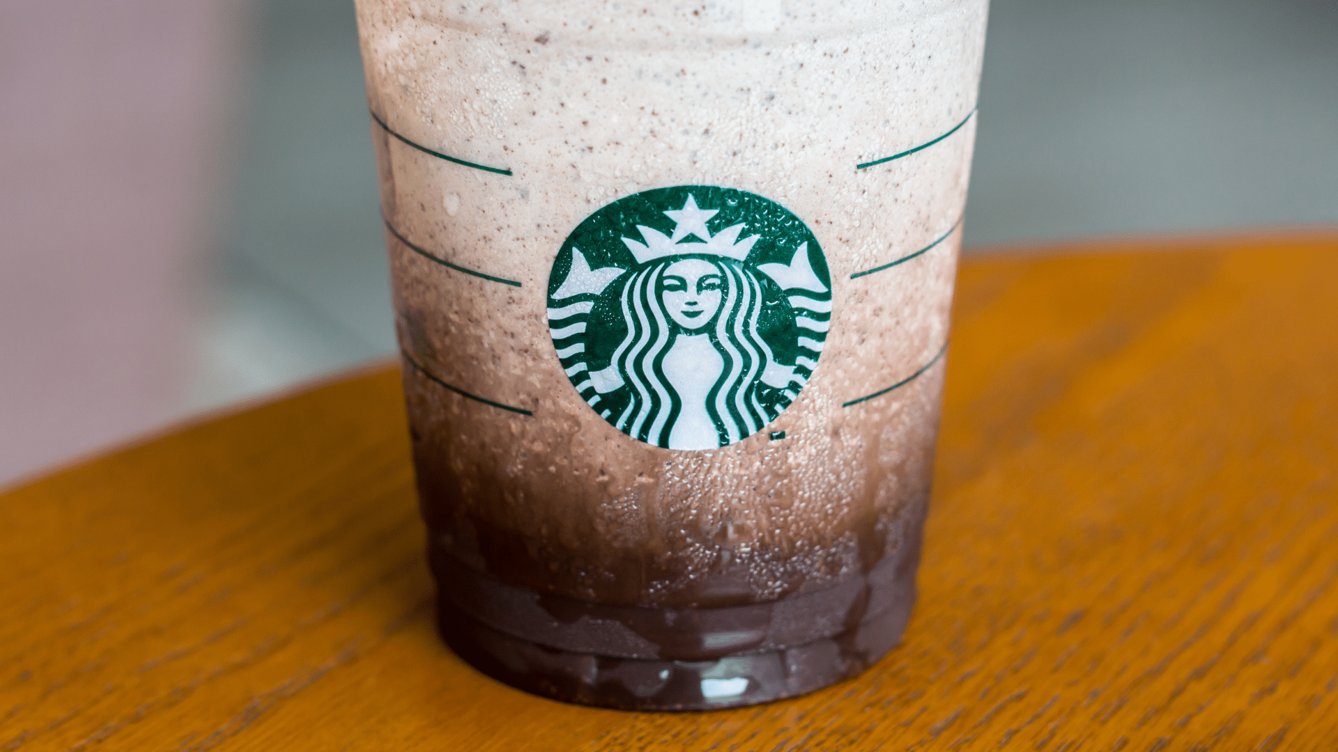 Close-up of a Starbucks iced blended drink in a clear plastic cup.