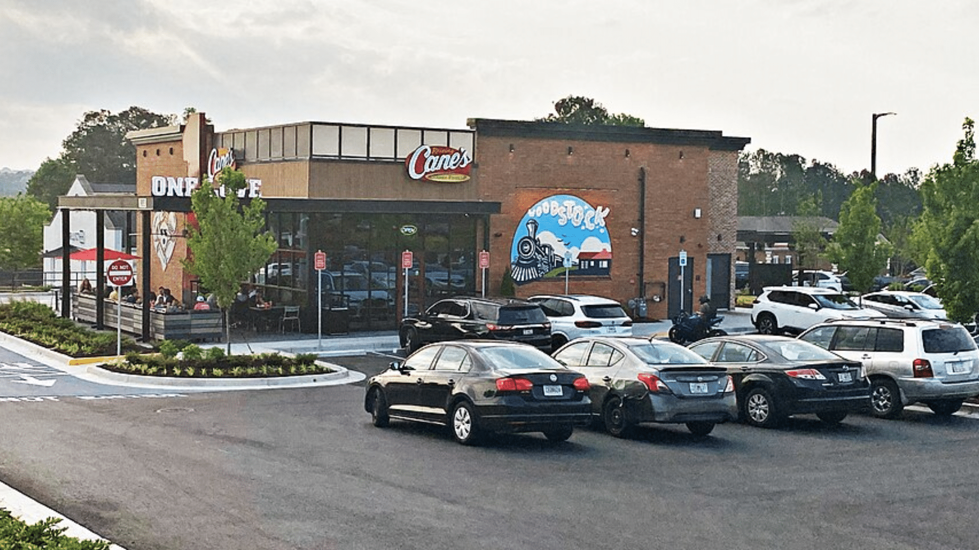 Raising Cane's restaurant featuring a "Woodstock" mural.