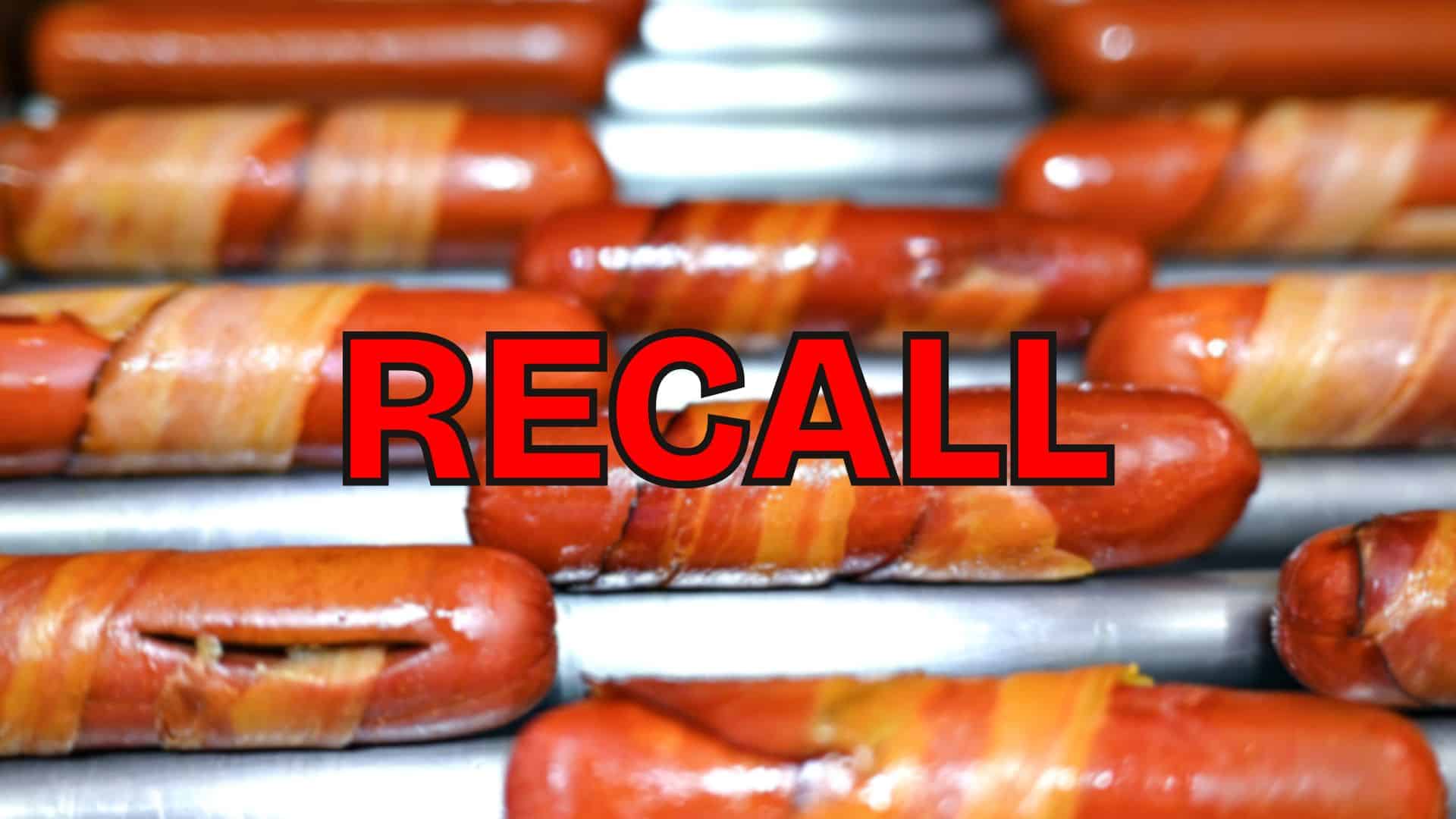 Bacon-wrapped hot dogs on a grill with bold red “RECALL” text highlighting a nationwide meat recall.